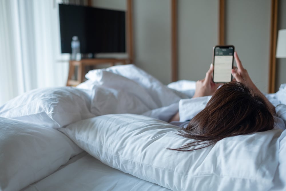 woman talking on the phone in bed