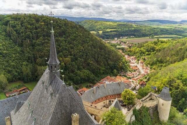 Medieval Karlstejn Castle on a hill surrounded by forest near Prague