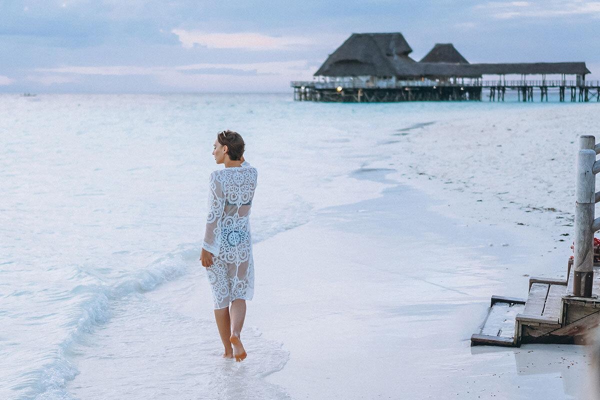 A girl on a beach in a luxury travel destination in Asia