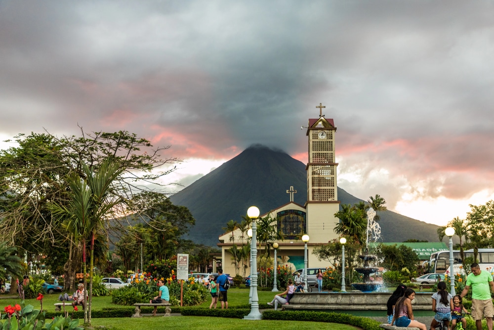 Arenal Volcano looming over the town square and church in La Fortuna Costa Rica